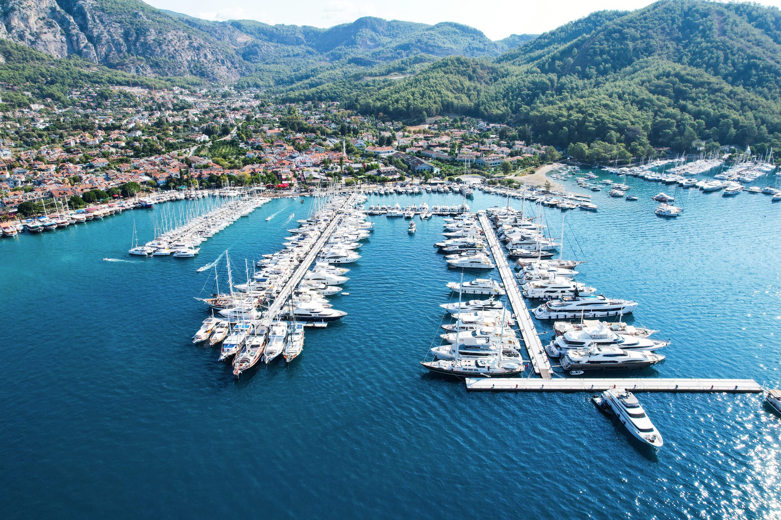 Göcek marina promenade at sunset with luxury yachts and palm trees